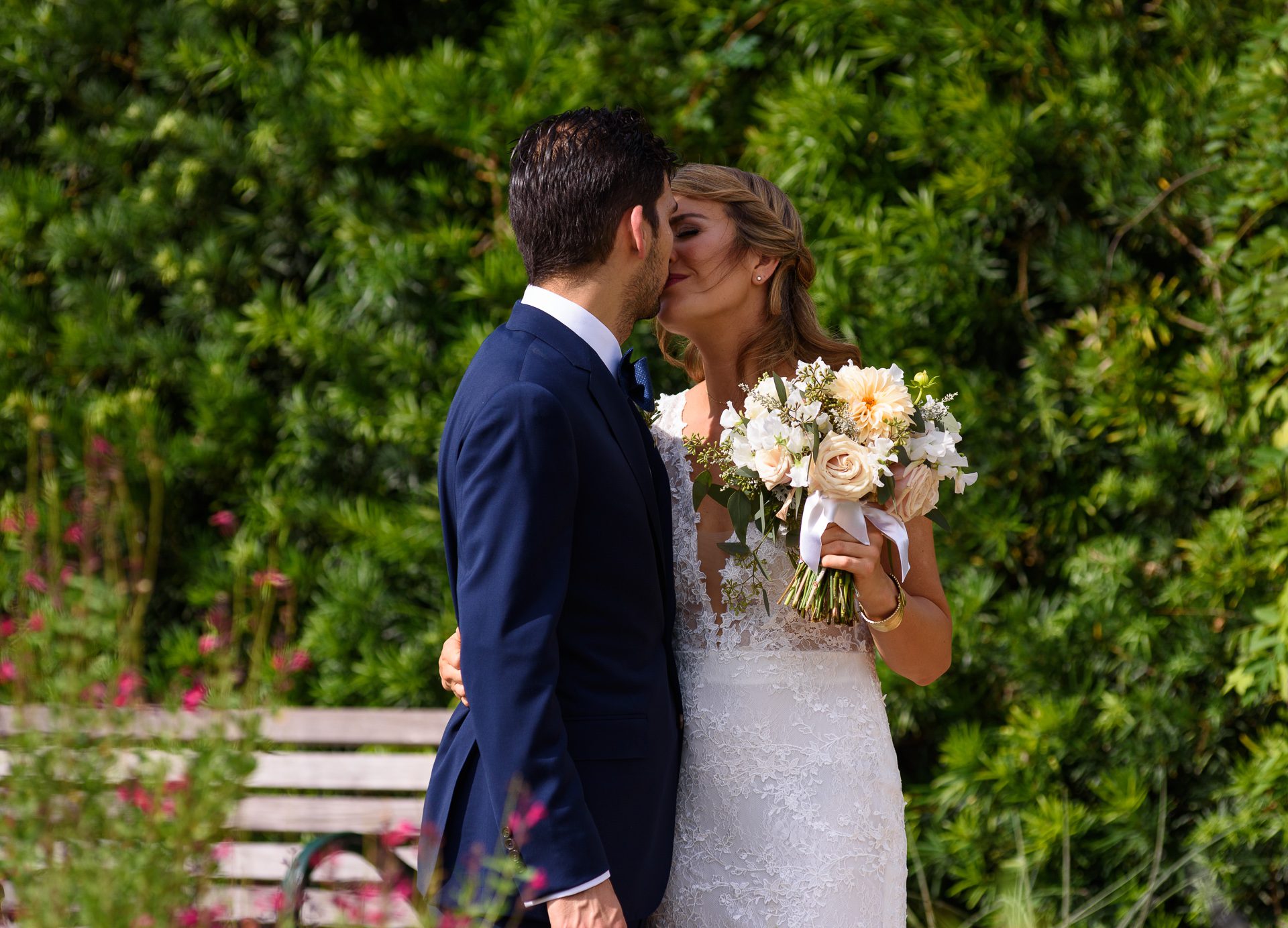 Bride and groom share a moment and a kiss during their first look